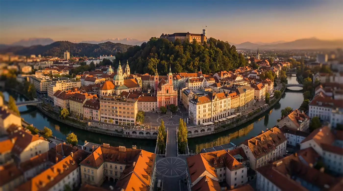 Slovenia residency by investment 2026, Ljubljana cityscape with Alpine backdrop, NTL International